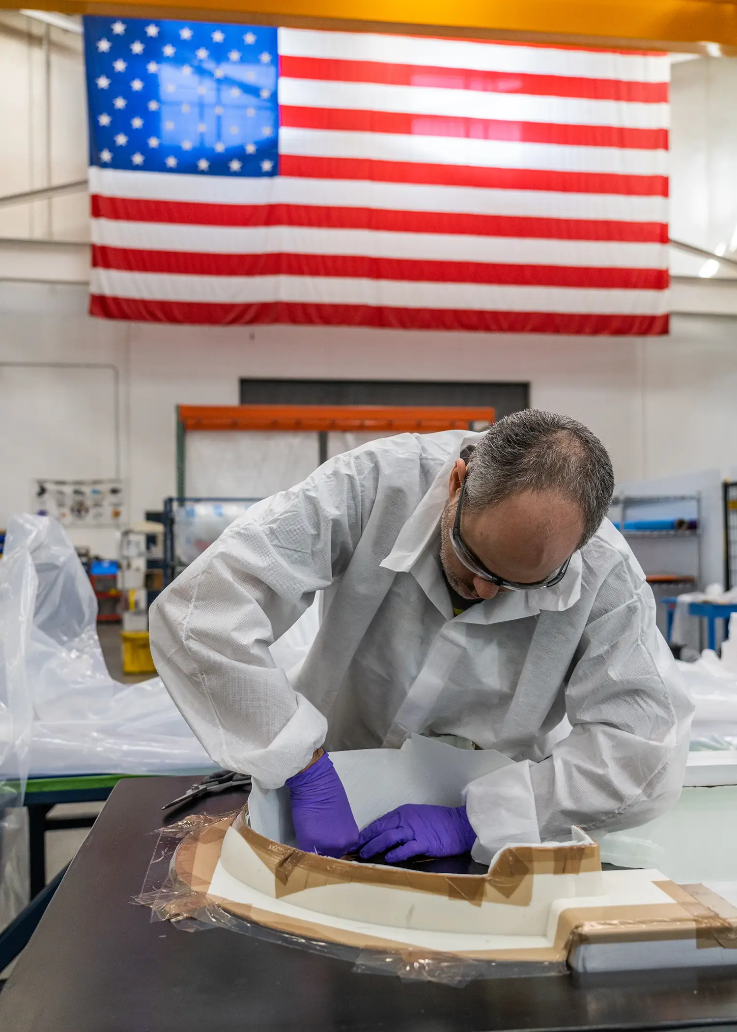 Molding worker in front of U.S. Flag