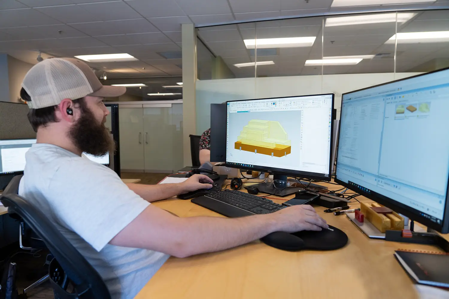 Janicki employee at desk drawing up layout of marine craft