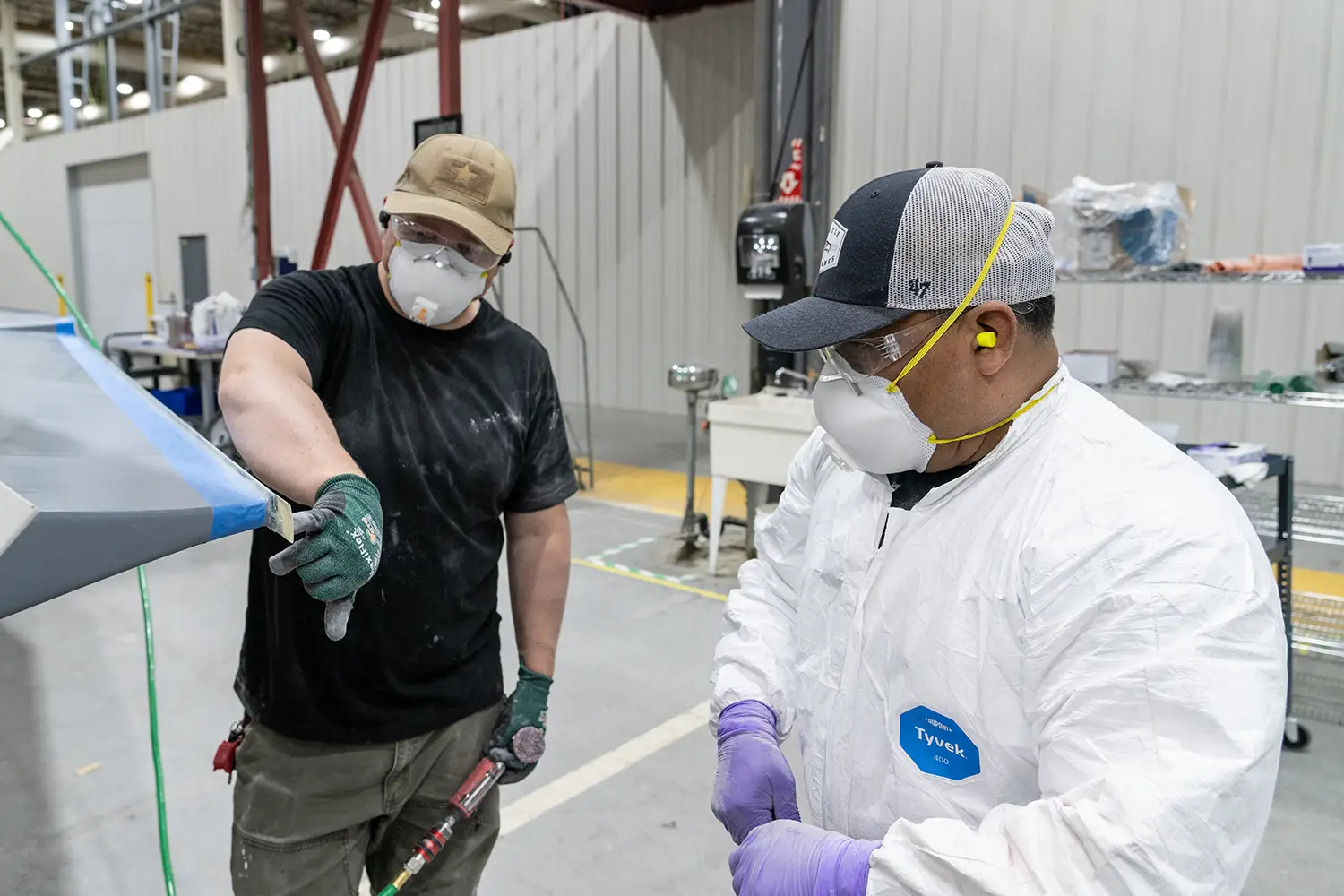 employees working on the corner measurement of a product