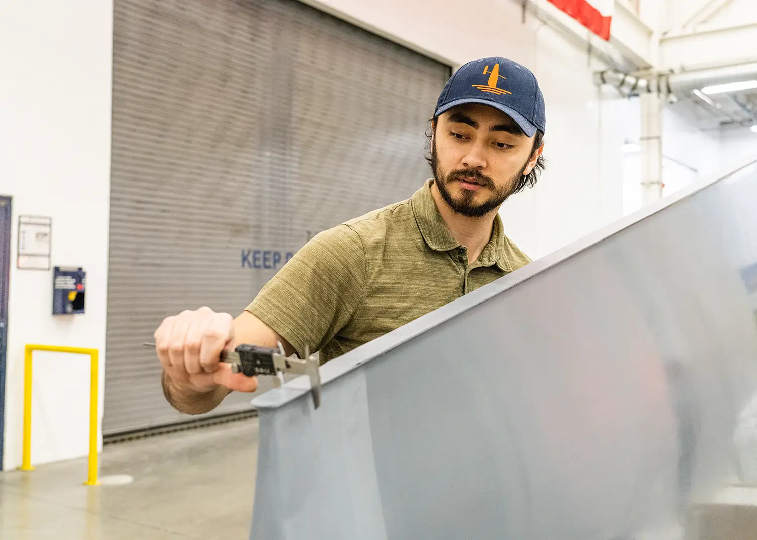 Janicki employee measuring tolerances of panel