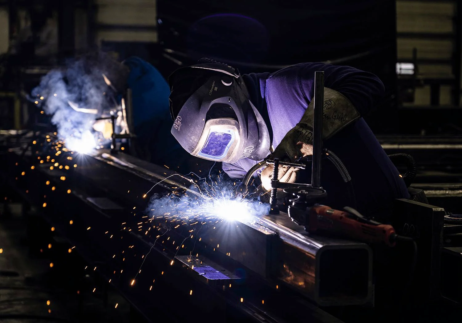 Two people welding